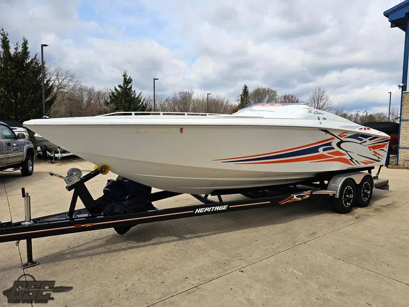 Slide: The Image of 2005 Baja 25 Outlaw speedboat on trailer, featuring sleek design and vibrant graphics. - 18