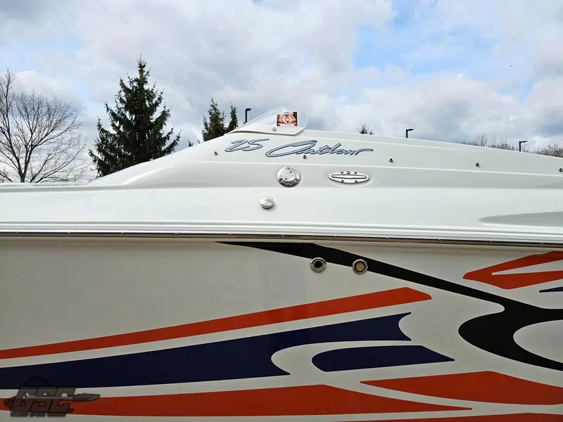 Slide: The Image of 2005 Baja 25 Outlaw boat with vibrant graphics and sleek design. - 25