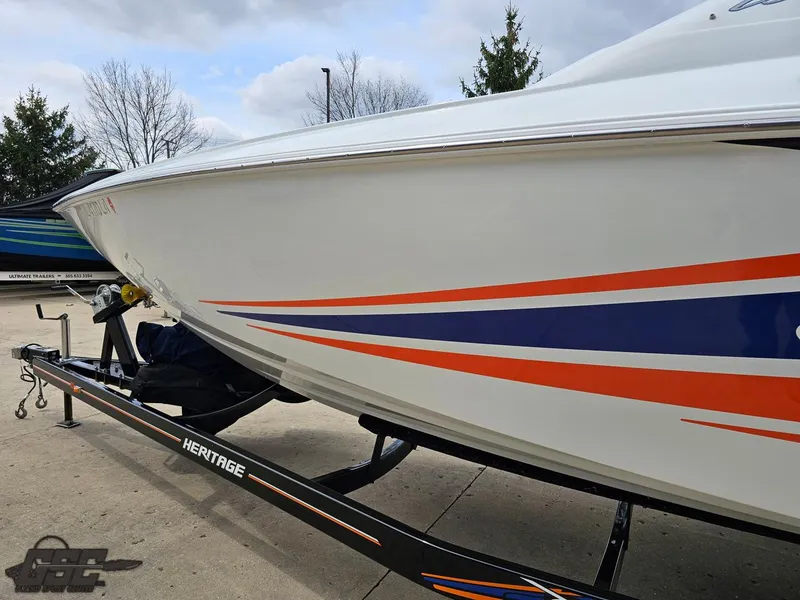 Slide: The Image of 2005 Baja 25 Outlaw boat on trailer with orange and blue stripes. - 26