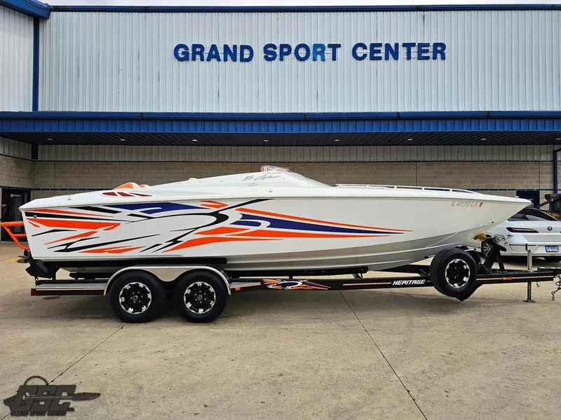 Slide: The Image of 2005 Baja 25 Outlaw speedboat with vibrant graphics at Grand Sport Center. - 3