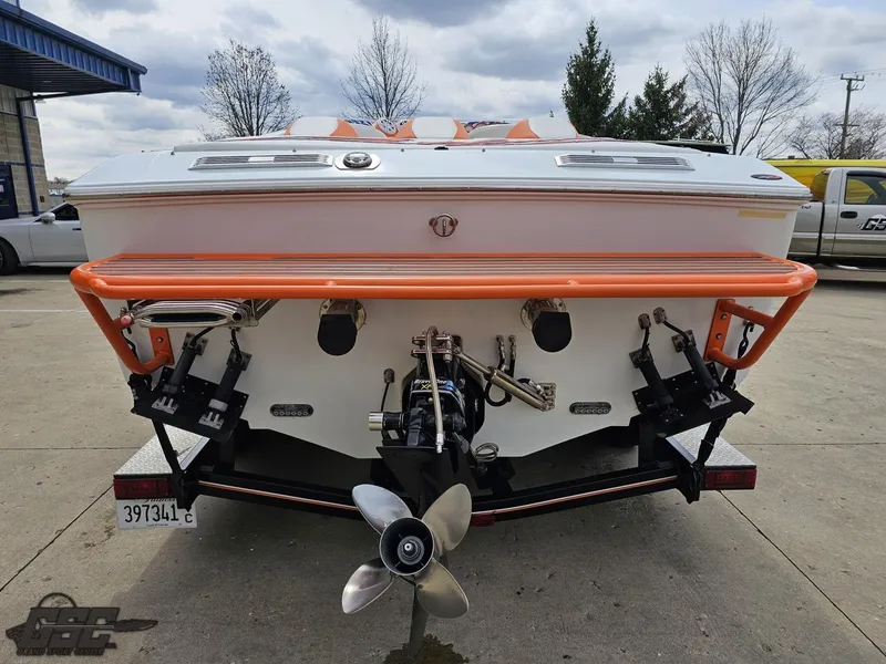 Slide: The Image of 2005 Baja 25 Outlaw boat rear view with orange accents and propeller. - 33