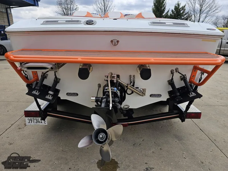 Slide: The Image of 2005 Baja 25 Outlaw boat rear view with orange accents and propeller. - 34
