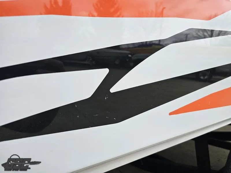 Slide: The Image of 2005 Baja 25 Outlaw boat with bold orange and black graphics. - 39