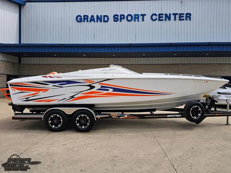 Slide: The Image of 2005 Baja 25 Outlaw speedboat with vibrant graphics at Grand Sport Center. - 4