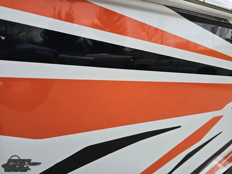 Slide: The Image of 2005 Baja 25 Outlaw boat with vibrant orange and black graphic design. - 40