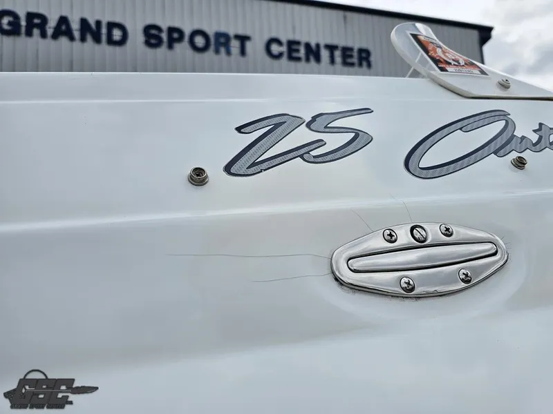 Slide: The Image of 2005 Baja 25 Outlaw boat at Grand Sport Center, showcasing sleek design details. - 41