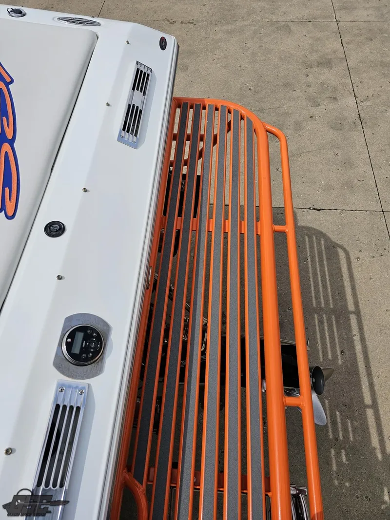 Slide: The Image of 2005 Baja 25 Outlaw boat with orange railing on a concrete surface. - 42