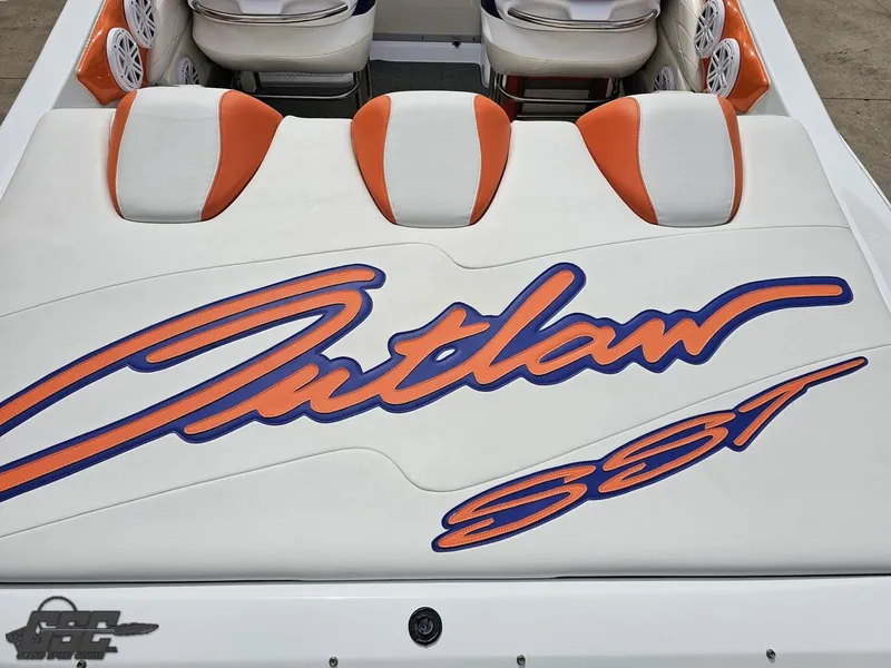 Slide: The Image of 2005 Baja 25 Outlaw boat with orange and white seating, featuring "Outlaw SST" logo. - 44