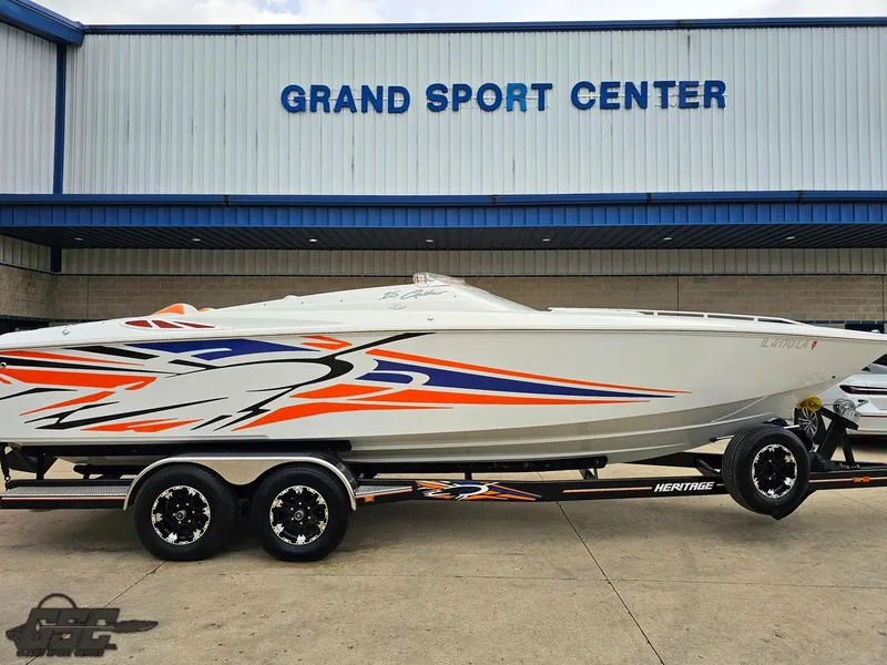 Slide: The Image of 2005 Baja 25 Outlaw boat with vibrant graphics at Grand Sport Center. - 5