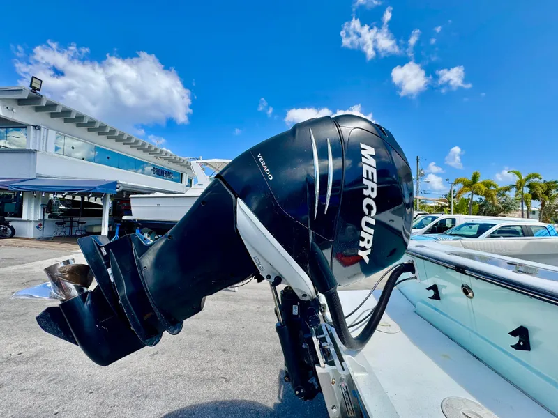Slide: The Image of 1963 Bertram 25 Mark II sport cruiser with Mercury outboard motor, docked under blue sky. - 18