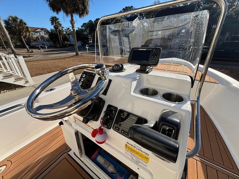 Slide: The Image of 2023 Sea Pro 172 Bay boat console with steering wheel, navigation system, and cup holders. - 10