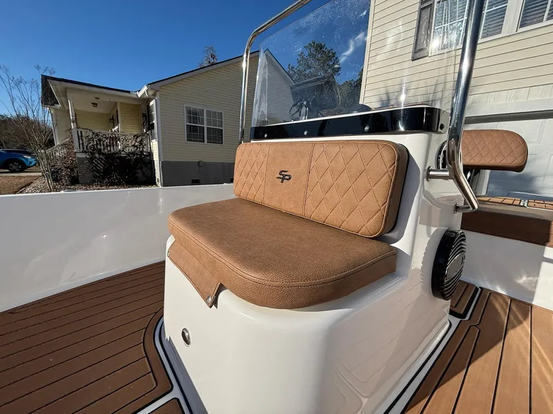 Slide: The Image of 2023 Sea Pro 172 Bay boat with brown cushioned seating and sleek design. - 12