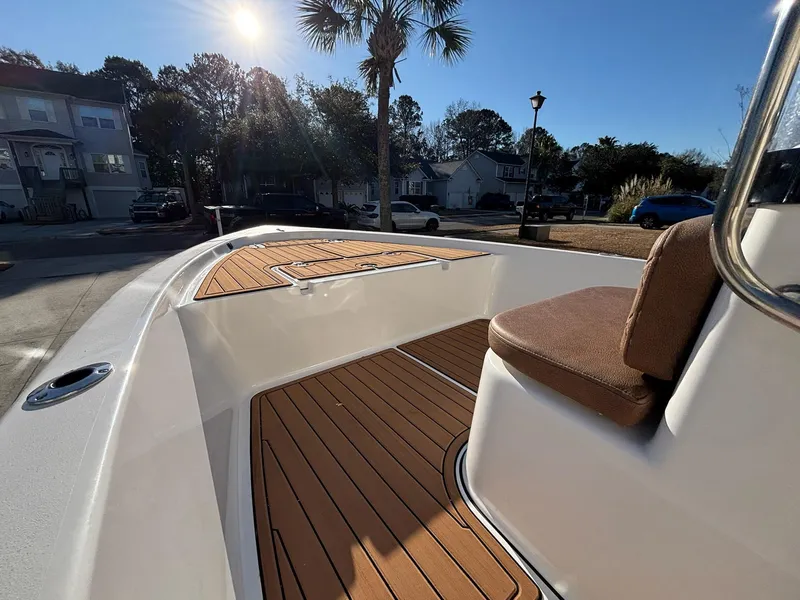 Slide: The Image of 2023 Sea Pro 172 Bay boat with teak deck, parked under sunny skies. - 13