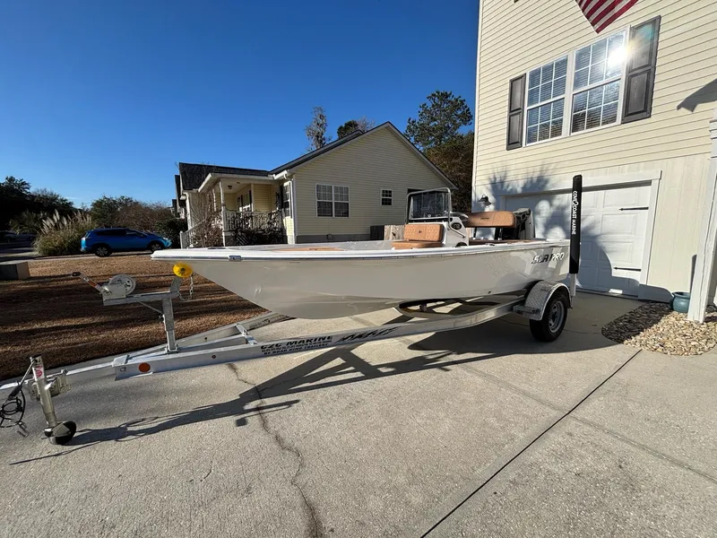 Slide: The Image of 2023 Sea Pro 172 Bay boat on trailer parked in driveway, sunny day. - 14