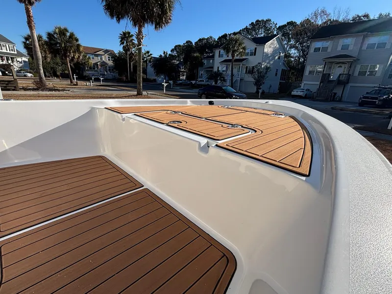 Slide: The Image of 2023 Sea Pro 172 Bay boat deck with wood finish, residential background. - 17