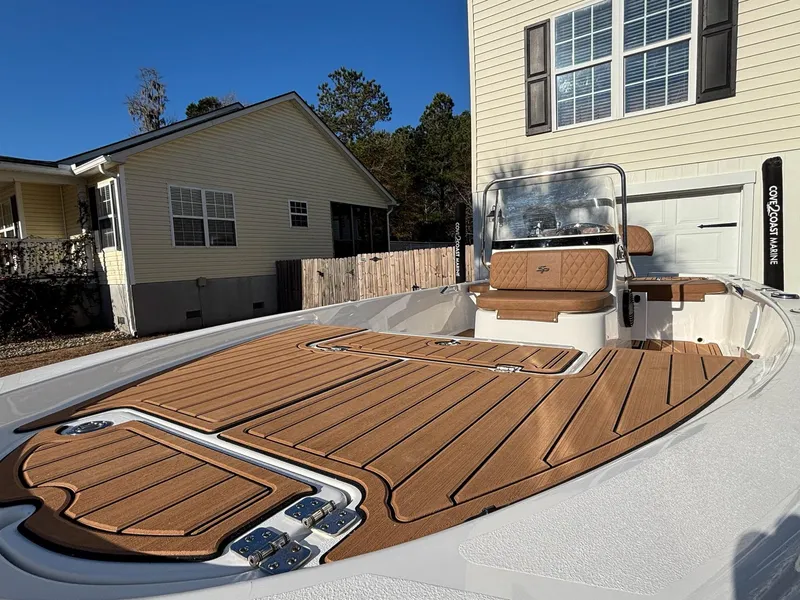 Slide: The Image of 2023 Sea Pro 172 Bay boat with sleek deck design, parked near residential homes. - 18