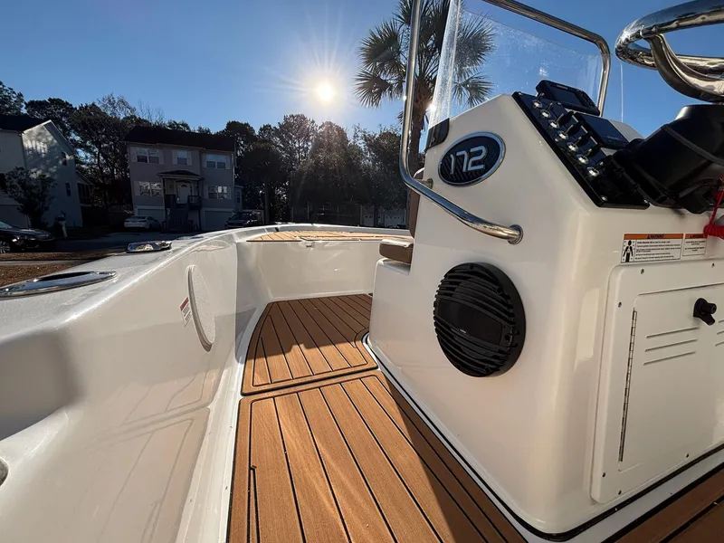 Slide: The Image of 2023 Sea Pro 172 Bay boat interior with wooden deck, under bright sunlight. - 5