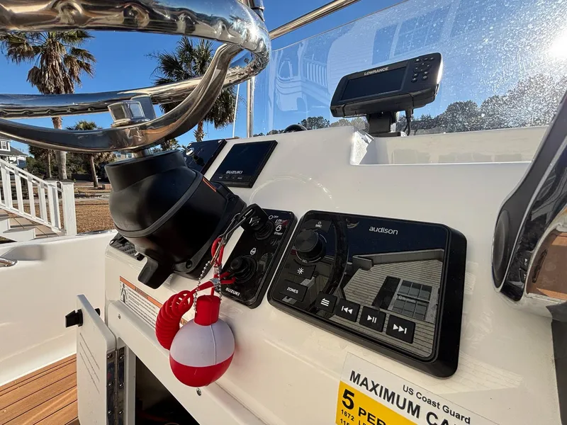 Slide: The Image of 2023 Sea Pro 172 Bay boat dashboard with steering wheel and control panel. - 9