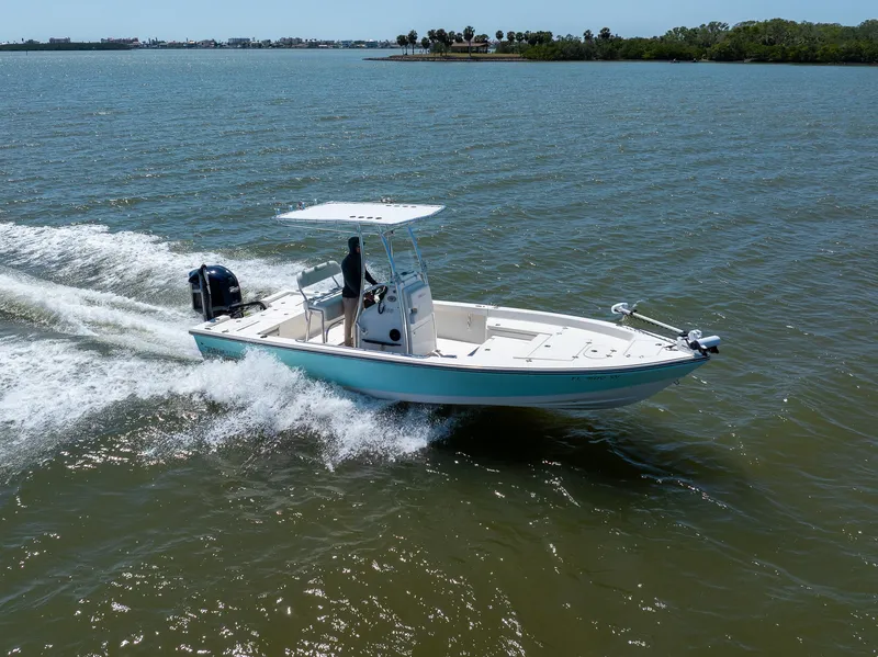 Slide: The Image of 2018 Pathfinder 2400 TRS boat cruising on open water, showcasing sleek design and performance. - 13