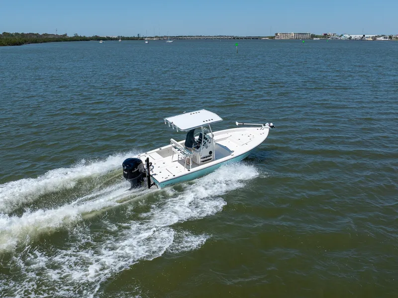 Slide: The Image of 2018 Pathfinder 2400 TRS boat cruising on open water under clear blue sky. - 14