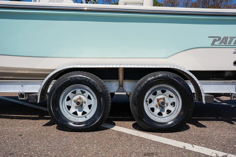 Slide: The Image of 2018 Pathfinder 2400 TRS boat on trailer with dual wheels, parked on asphalt. - 17