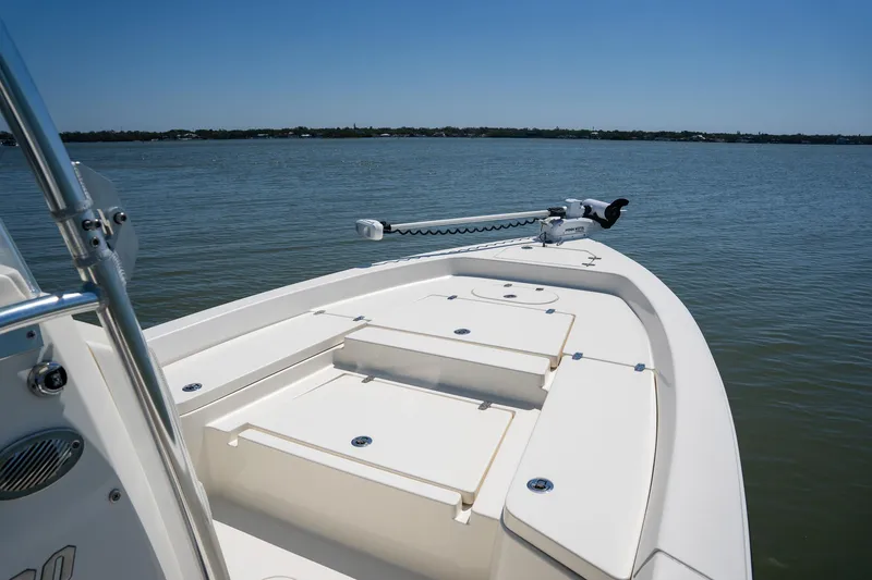 Slide: The Image of 2018 Pathfinder 2400 TRS boat on calm water, featuring spacious deck and trolling motor. - 21