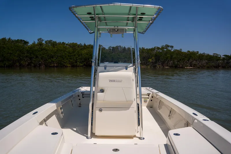 Slide: The Image of 2018 Pathfinder 2400 TRS boat on calm water with lush greenery in the background. - 35