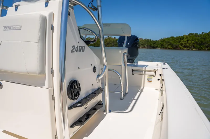 Slide: The Image of 2018 Pathfinder 2400 TRS boat on water, featuring sleek design and modern controls. - 36