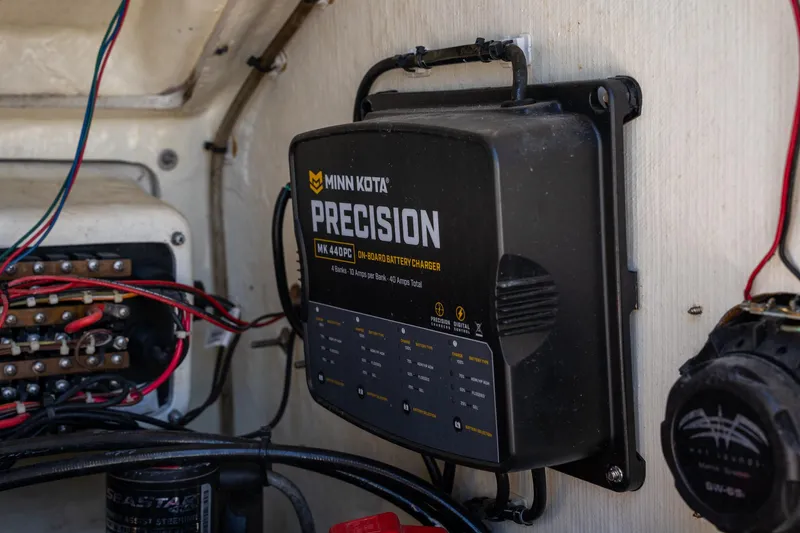 Slide: The Image of Minn Kota Precision charger inside 2018 Pathfinder 2400 TRS boat, with visible wiring. - 41