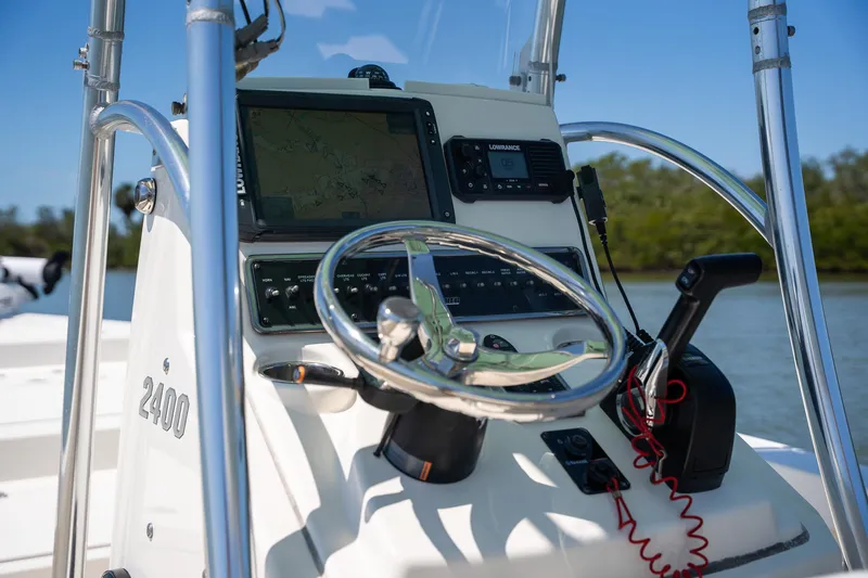 Slide: The Image of Control panel of 2018 Pathfinder 2400 TRS boat with steering wheel and navigation equipment. - 43