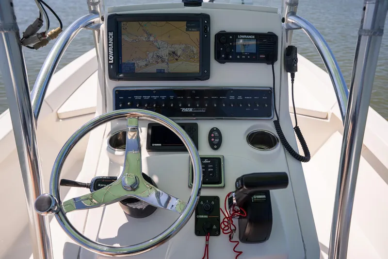 Slide: The Image of 2018 Pathfinder 2400 TRS boat console with steering wheel, navigation system, and controls. - 44