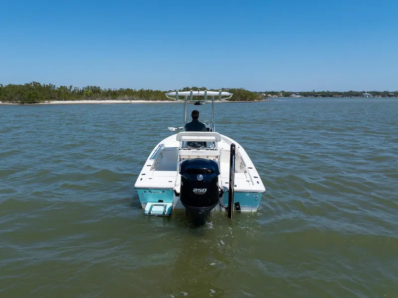 Slide: The Image of 2018 Pathfinder 2400 TRS boat cruising on a calm lake under clear blue skies. - 5