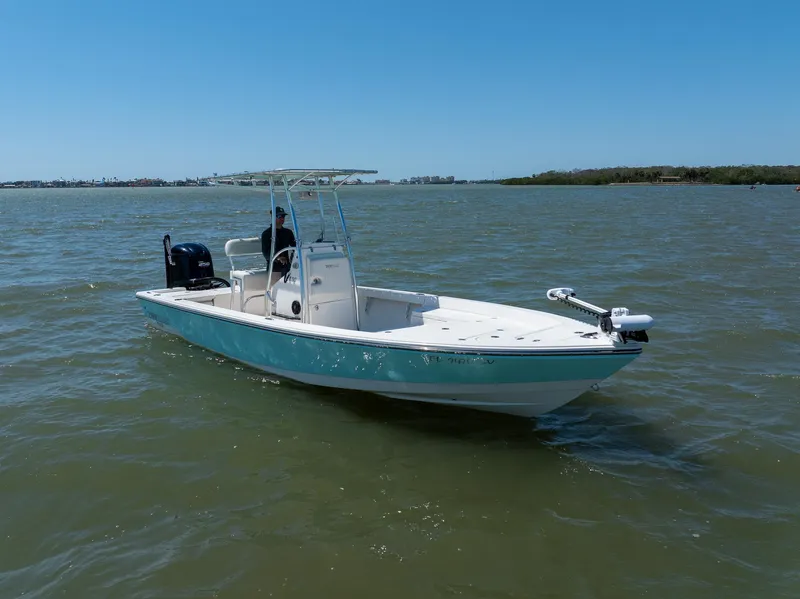 Slide: The Image of 2018 Pathfinder 2400 TRS boat on open water under clear blue sky. - 7