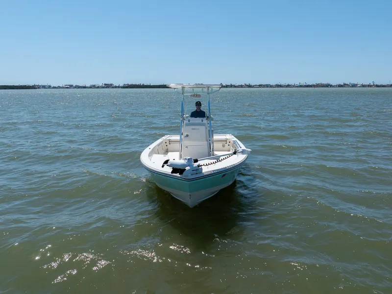 Slide: The Image of 2018 Pathfinder 2400 TRS boat on open water under clear blue sky. - 8
