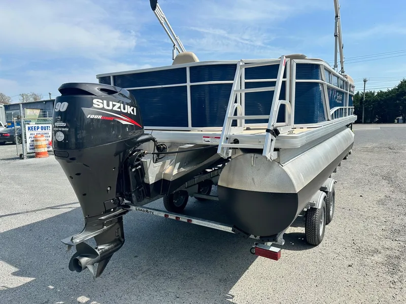 Slide: The Image of 2015 Godfrey Sweetwater 2086FCS pontoon boat with Suzuki outboard motor on trailer. - 2