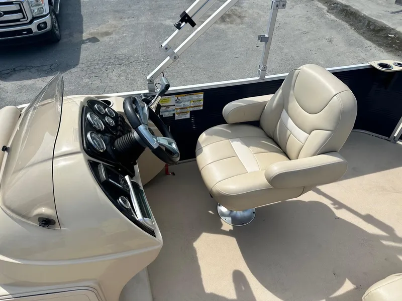 Slide: The Image of Captain's seat and console of a 2015 Godfrey Sweetwater 2086FCS boat. - 4