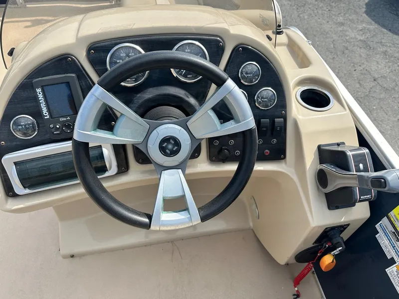 Slide: The Image of Steering console of 2015 Godfrey Sweetwater 2086FCS boat with gauges and controls. - 5