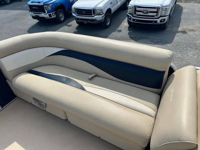 Slide: The Image of 2015 Godfrey Sweetwater 2086FCS boat interior with beige and navy seating. - 6