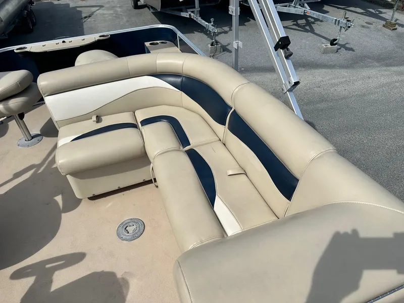 Slide: The Image of 2015 Godfrey Sweetwater 2086FCS boat interior with beige and navy seating. - 8