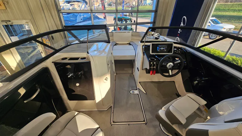 Slide: The Image of 2023 Yamaha Boats AR250 interior with modern dashboard and seating. - 13
