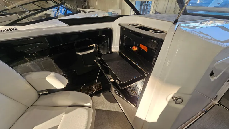 Slide: The Image of 2023 Yamaha Boats AR250 interior with seating and storage compartment. - 14