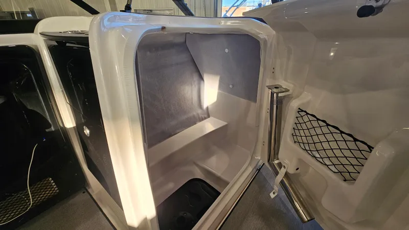 Slide: The Image of 2023 Yamaha AR250 boat storage compartment with interior lighting and netted pocket. - 15