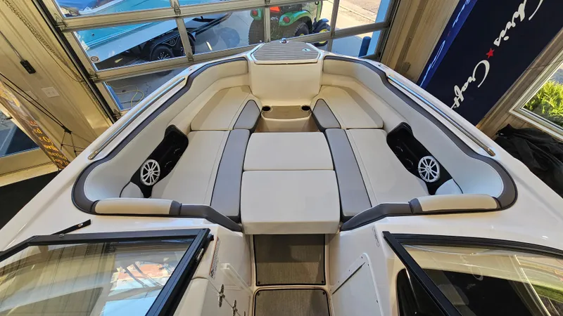 Slide: The Image of 2023 Yamaha Boats AR250 interior with spacious seating and modern design. - 16