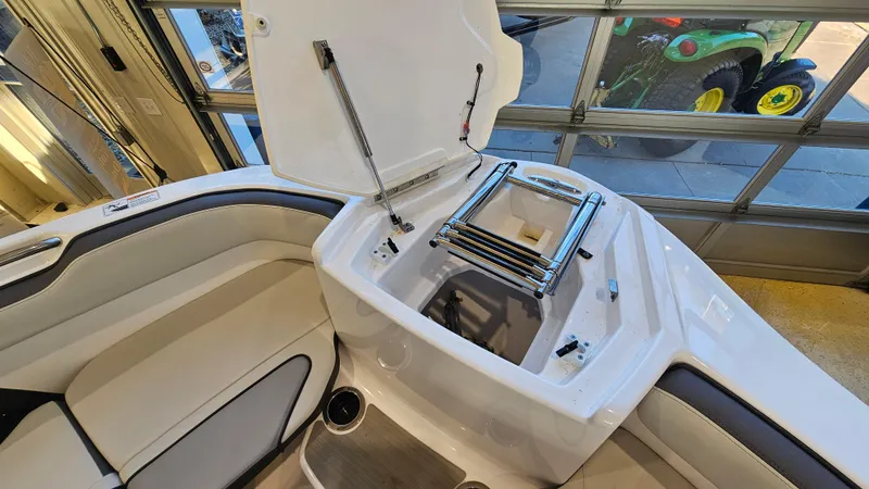 Slide: The Image of 2023 Yamaha AR250 boat interior with open storage compartment and seating area. - 19