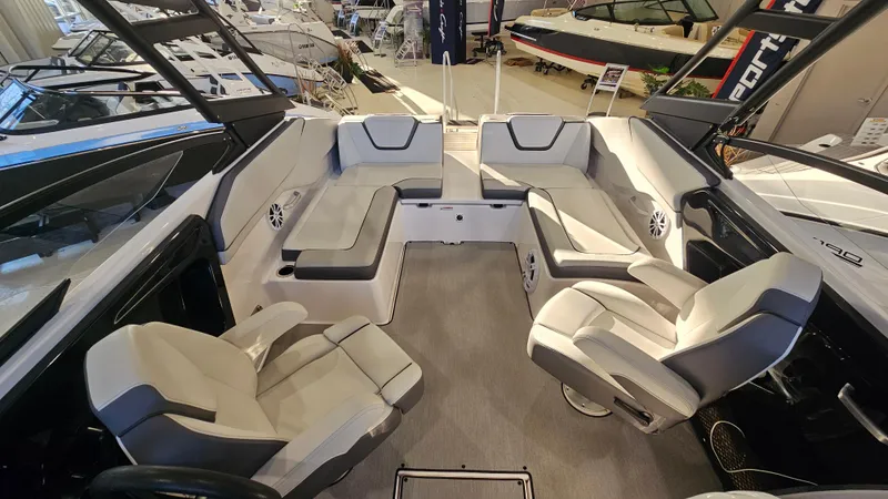 Slide: The Image of 2023 Yamaha Boats AR250 interior with spacious seating and modern design. - 5