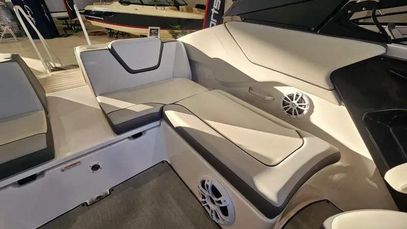 Slide: The Image of 2023 Yamaha Boats AR250 interior with cushioned seating and built-in speakers. - 6