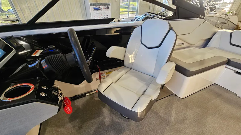 Slide: The Image of 2023 Yamaha Boats AR250 interior with modern seating and steering wheel. - 9