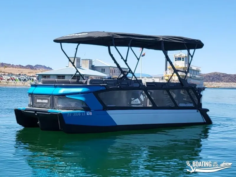 Slide: The Image of 2023 Sea-Doo Switch Cruise 21 pontoon boat on a calm lake. - 10