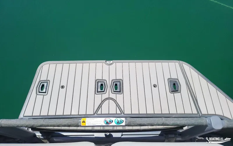 Slide: The Image of 2023 Sea-Doo Switch Cruise 21 deck over clear green water. - 21