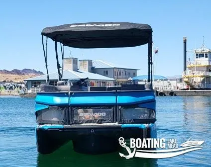 Slide: The Image of 2023 Sea-Doo Switch Cruise 21 on Lake Mead, with marina and buildings in the background. - 7